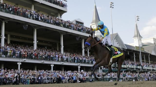 FILE - Victor Espinoza rides American Pharoah to victory in the 141st running of the Kentucky Derby horse race at Churchill Downs in Louisville, Ky., May 2, 2015.(AP Photo/David J. Phillip, File)