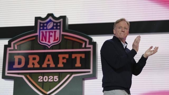 NFL Commissioner Roger Goodell motions on stage during the second round of the NFL football draft, Friday, April 25, 2025, in Green Bay, Wis. (AP Photo/Jeff Roberson)