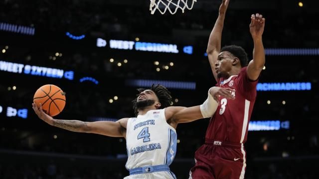 North Carolina guard RJ Davis (4) shoots past Alabama guard Rylan Griffen (3) during the first half of a Sweet 16 college basketball game in the NCAA tournament Thursday, March 28, 2024, in Los Angeles. (AP Photo/Ashley Landis)