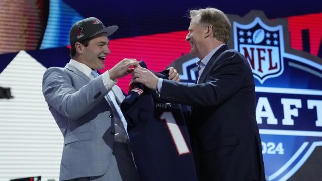 North Carolina quarterback Drake Maye, left, celebrates with NFL Commissioner Roger Goodell after being chosen by the New England Patriots with the third overall pick during the first round of the NFL football draft, Thursday, April 25, 2024, in Detroit. (AP Photo/Jeff Roberson)