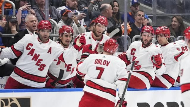 Carolina Hurricanes' Dmitry Orlov (7) is congratulated for his goal against the New York Islanders during the first period of Game 3 of an NHL hockey Stanley Cup first-round playoff series Thursday, April 25, 2024, in Elmont, N.Y. (AP Photo/Frank Franklin II)