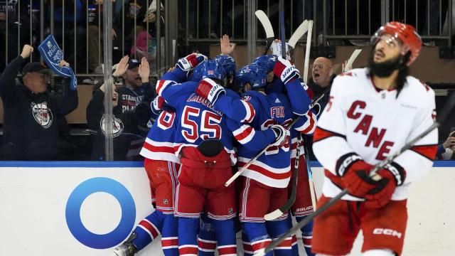 New York Rangers defenseman Ryan Lindgren, left wing Jimmy Vesey and others celebrate following center Mika Zibanejad's goal against the Carolina Hurricanes during the first period in Game 1 of an NHL hockey Stanley Cup second-round playoff series, Sunday, May 5, 2024, in New York. (AP Photo/Julia Nikhinson)