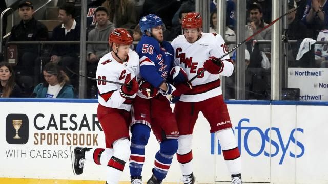 Carolina Hurricanes center Martin Necas, defenseman Brady Skjei and New York Rangers left wing Will Cuylle fight for the puck during the first period in Game 1 of an NHL hockey Stanley Cup second-round playoff series, Sunday, May 5, 2024, in New York. (AP Photo/Julia Nikhinson)