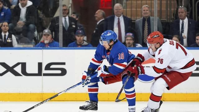 New York Rangers left wing Artemi Panarin (10) and Carolina Hurricanes defenseman Brady Skjei (76) fight for the puck during the third period in Game 1 of an NHL hockey Stanley Cup second-round playoff series, Sunday, May 5, 2024, in New York. (AP Photo/Julia Nikhinson)