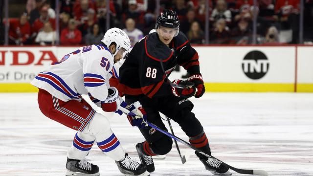 Carolina Hurricanes' Martin Necas (88) chases the puck with New York Rangers' Erik Gustafsson (56) during the second period in Game 4 of an NHL hockey Stanley Cup second-round playoff series in Raleigh, N.C., Saturday, May 11, 2024. (AP Photo/Karl B DeBlaker)