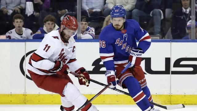 New York Rangers center Jack Roslovic (96) skates with the puck past Carolina Hurricanes center Jordan Staal in the first period during Game 5 of an NHL hockey Stanley Cup second-round playoff series, Monday, May 13, 2024, in New York. (AP Photo/Adam Hunger)