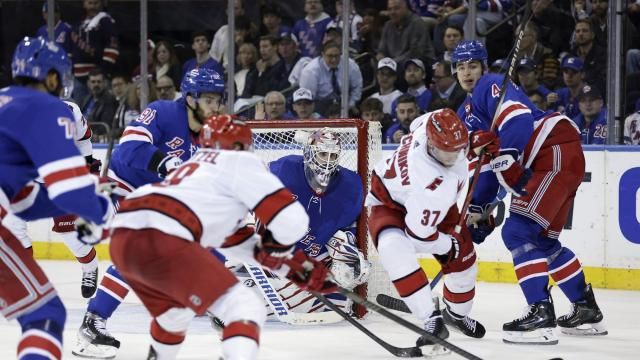 New York Rangers goaltender Igor Shesterkin, center, looks on as Carolina Hurricanes right wing Andrei Svechnikov (37) battles for the puck in the second period during Game 5 of an NHL hockey Stanley Cup second-round playoff series Monday, May 13, 2024, in New York. (AP Photo/Adam Hunger)