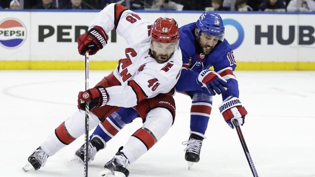 Carolina Hurricanes left wing Jordan Martinook (48) and New York Rangers center Vincent Trocheck, right, battle for the puck in the second period during Game 5 of an NHL hockey Stanley Cup second-round playoff series Monday, May 13, 2024, in New York. (AP Photo/Adam Hunger)