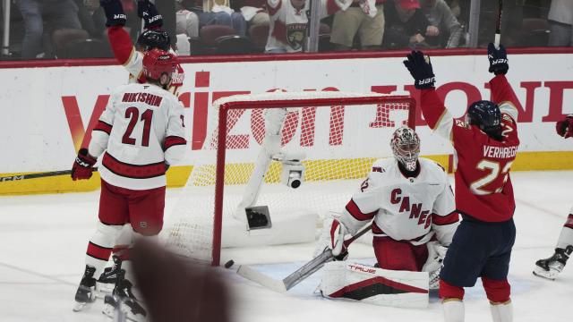 The puck gets past Carolina Hurricanes goaltender Pyotr Kochetkov, center, on a goal scored by Florida Panthers' Aleksander Barkov during the third period in Game 3 of the NHL hockey Stanley Cup Eastern Conference finals Saturday, May 24, 2025, in Sunrise, Fla. (AP Photo/Lynne Sladky)
