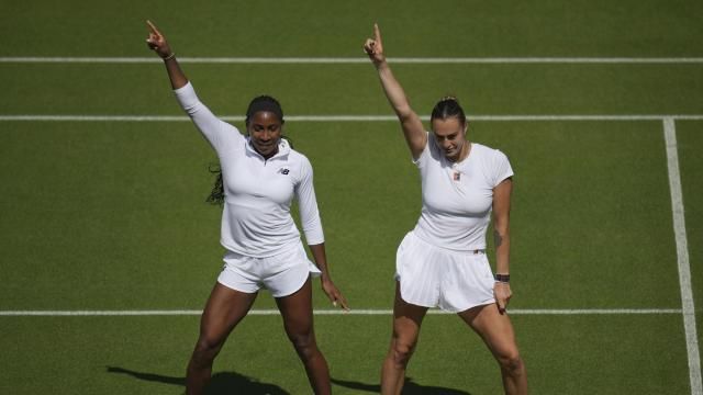 Aryna Sabalenka of Belarus, right, and Coco Gauff of United States dance during a practice session ahead of the Wimbledon Championships in London, Friday, June 27, 2025. (AP Photo/Kin Cheung)